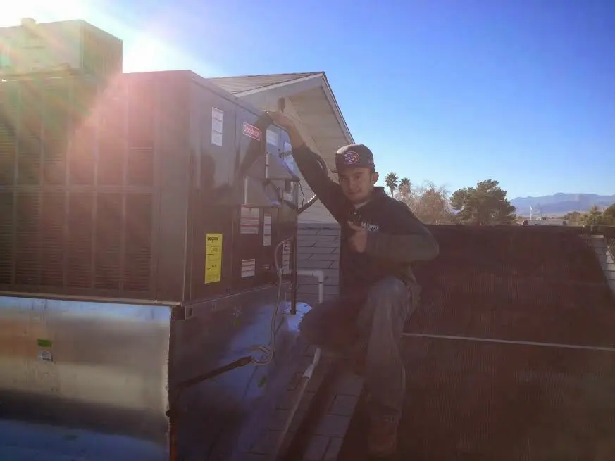 HVAC technician performing AC Tune-Up on a rooftop unit in Union Park